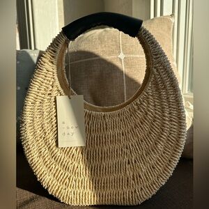 NWT a new day woven rattan moon shaped shoulder bag.